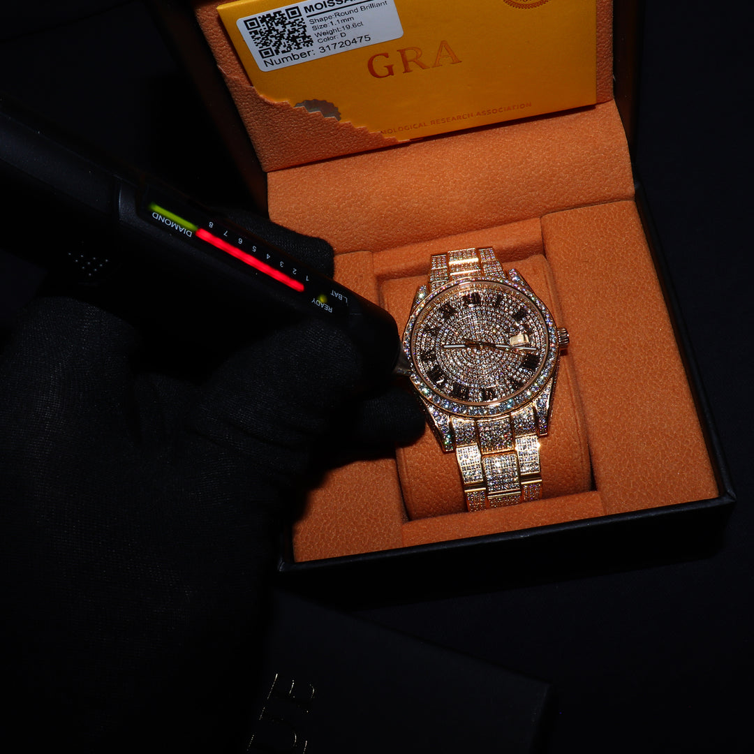 Fully iced VVS1 Corore gold watch with Roman numeral markers from ICECLIQUE JEWELRY, featuring sparkling moissanite accents.