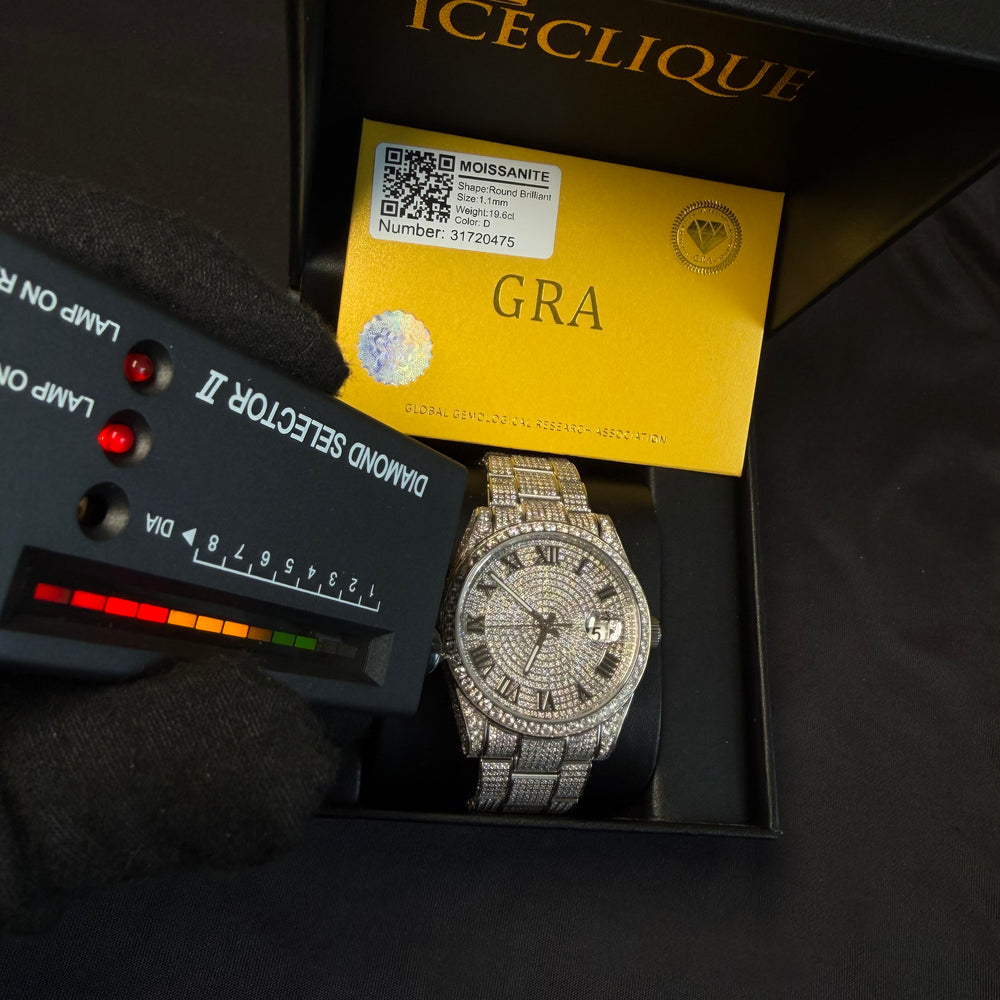 Fully iced VVS1 Moissanite Corore watch with white gold band featuring Roman numeral design from ICECLIQUE Jewelry.